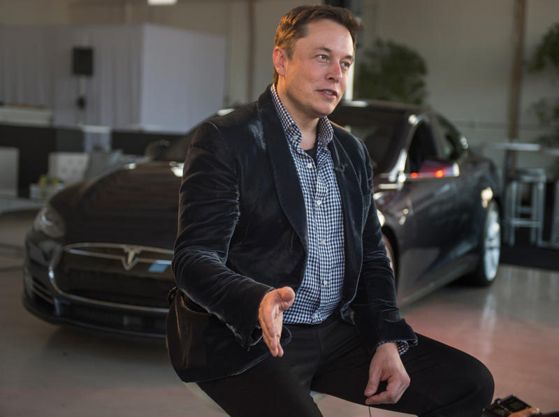 Elon Musk discussing Tesla technologies at an event