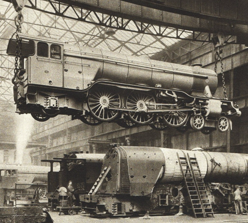 5. Mechanics hoisting a train engine in 1935.