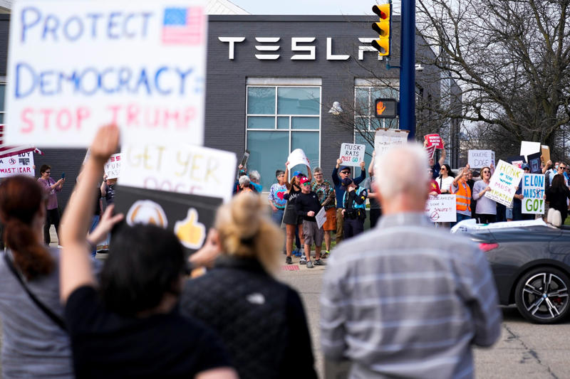 Protesters outside a Tesla dealership in Columbus, Ohio