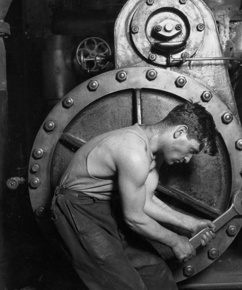 7. Powerhouse mechanic working on steam pump, 1920